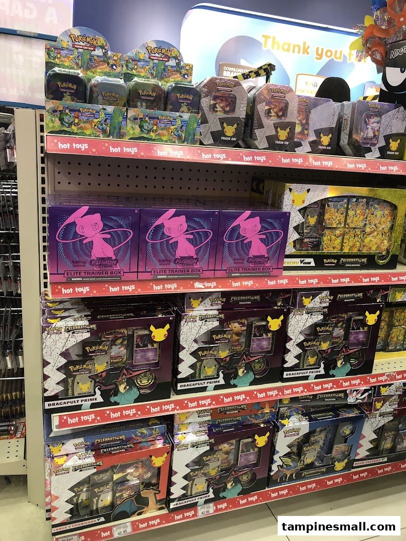 Shelves at ToysRUs filled with various Pokémon Trading Card Game products, including Elite Trainer Boxes.