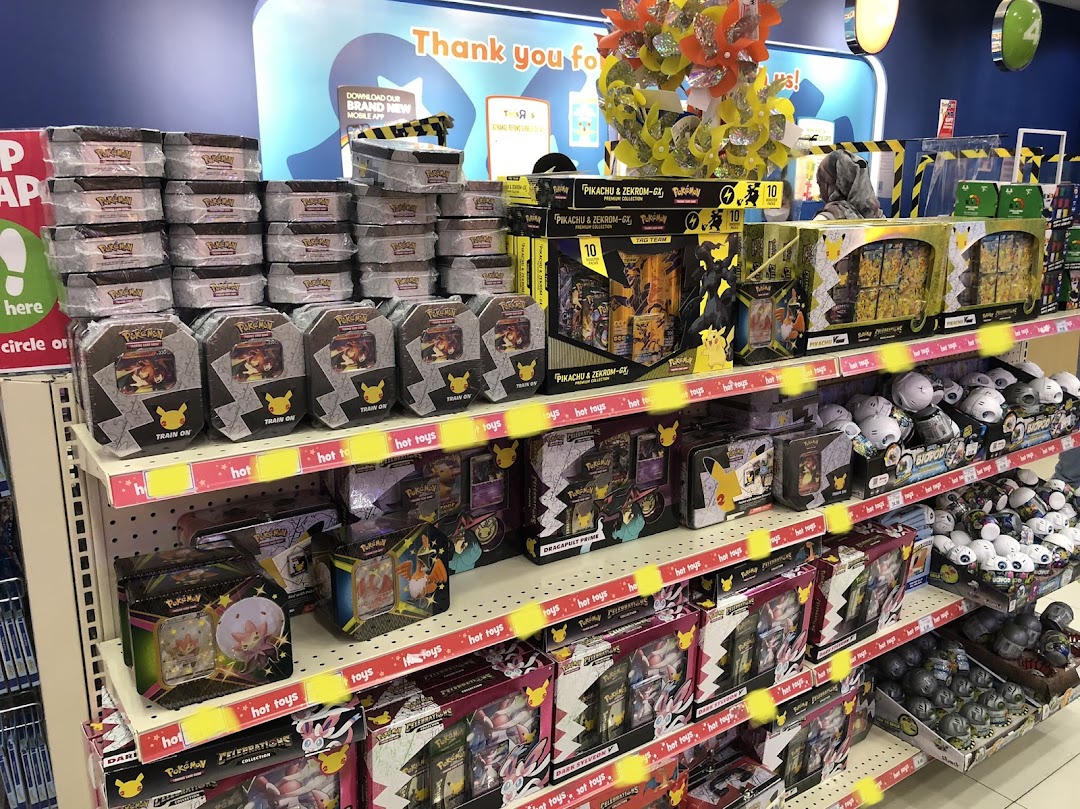 Shelves at ToysRUs filled with a wide variety of Pokémon trading card game products and merchandise.