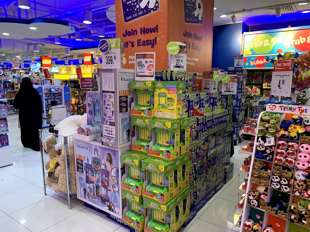 An interior view of ToysRUs Tampines Mall, showcasing diverse toy displays and promotions.
