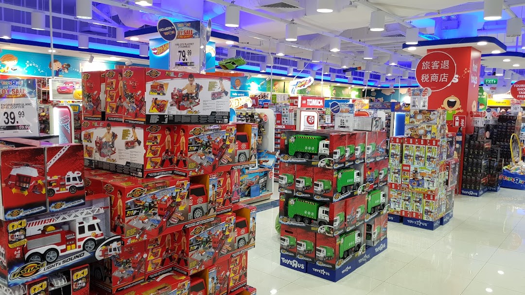 An interior view of ToysRUs, showcasing aisles filled with a wide variety of toys and games.