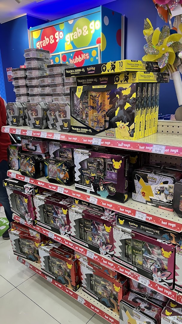 Shelves filled with various Pokémon trading card game products and merchandise at ToysRUs.