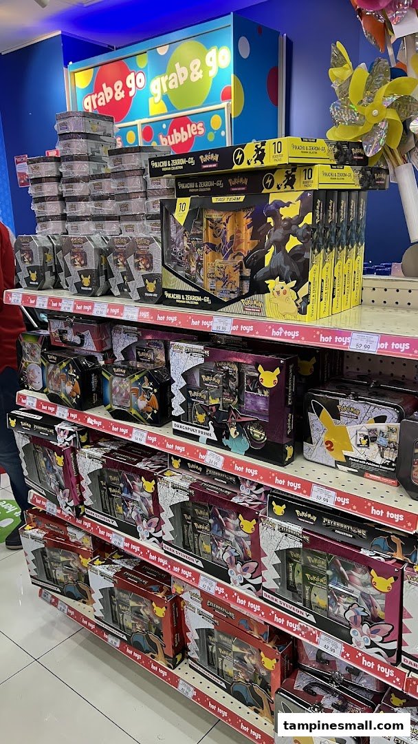 Shelves filled with various Pokémon trading card game products and merchandise at ToysRUs.