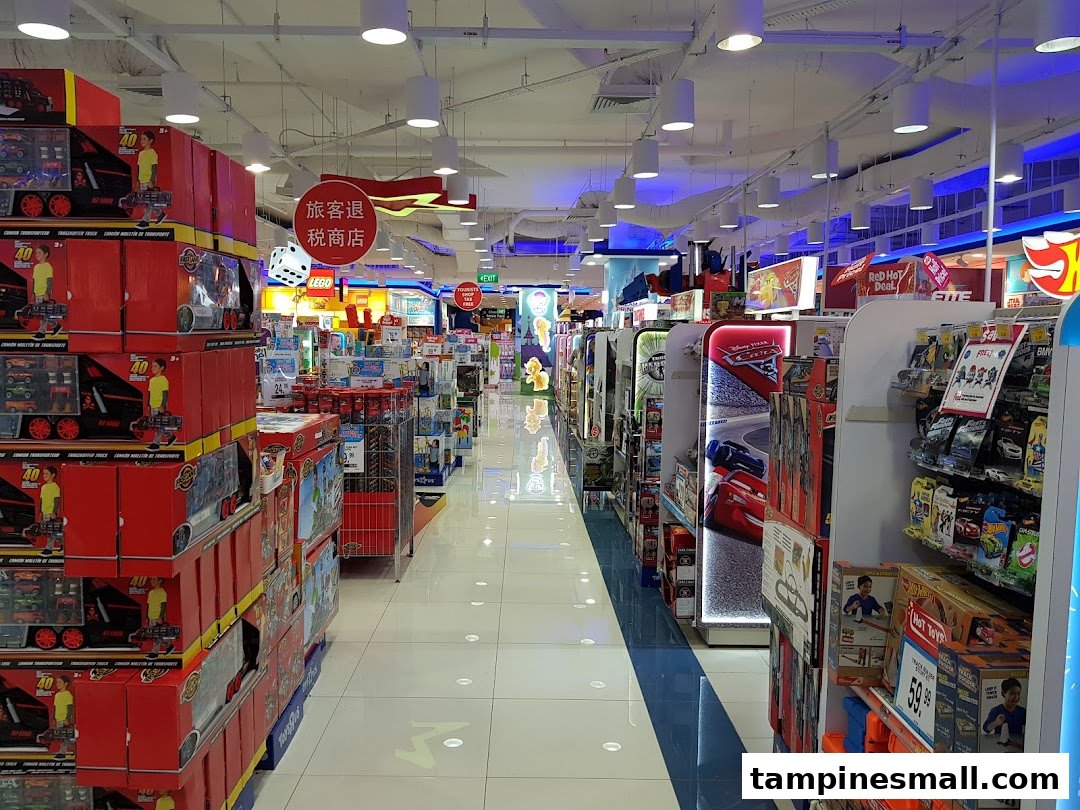A brightly lit aisle inside ToysRUs, showcasing a wide array of toys and merchandise on shelves.