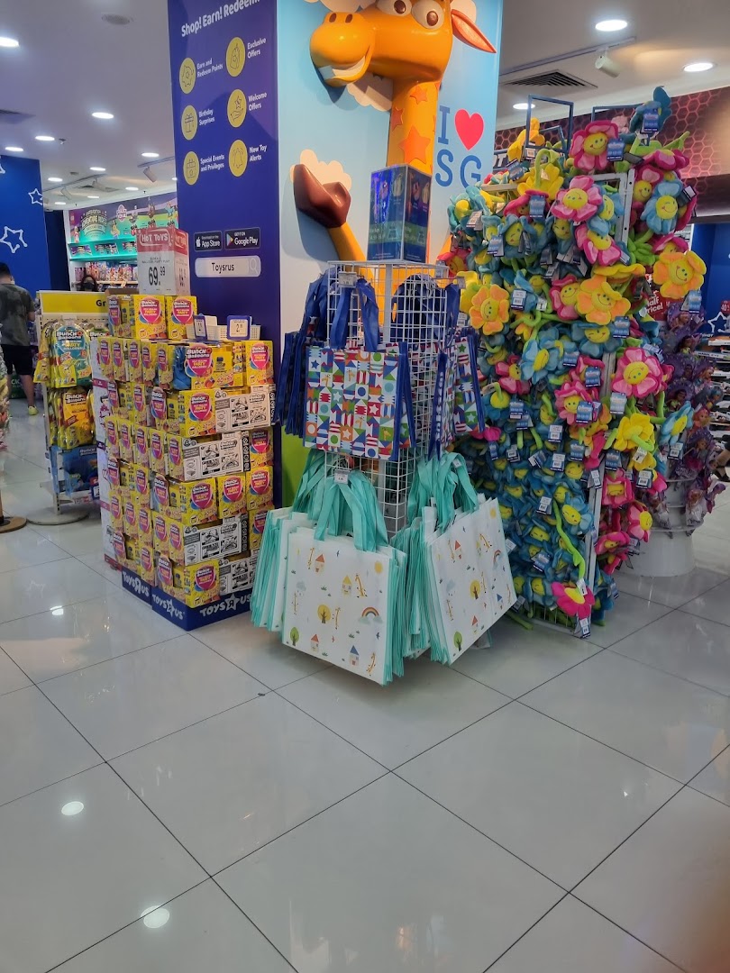 Vibrant interior of ToysRUs featuring colorful plush toys, reusable bags, and various toy displays.