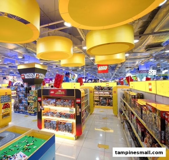 Brightly lit interior of ToysRUs, showcasing extensive Lego displays and various toy sections.