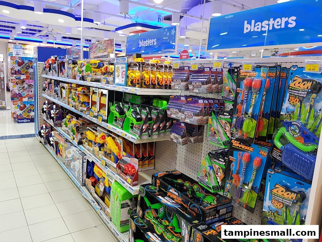 An aisle inside ToysRUs filled with various blasters, toy guns, and outdoor play items.