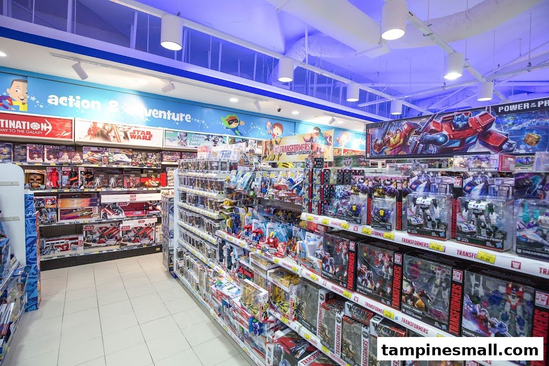 An interior shot of ToysRUs, featuring aisles stocked with action figures, Transformers, and Star Wars toys.