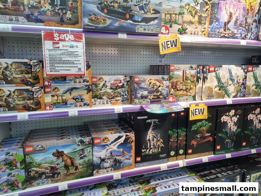 Shelves at ToysRUs filled with various LEGO sets, including Jurassic World, Avatar, and botanical collections.
