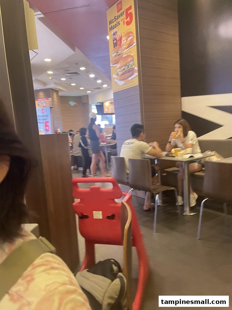 A bustling mall food court scene with diners enjoying meals, offering convenient dining options.