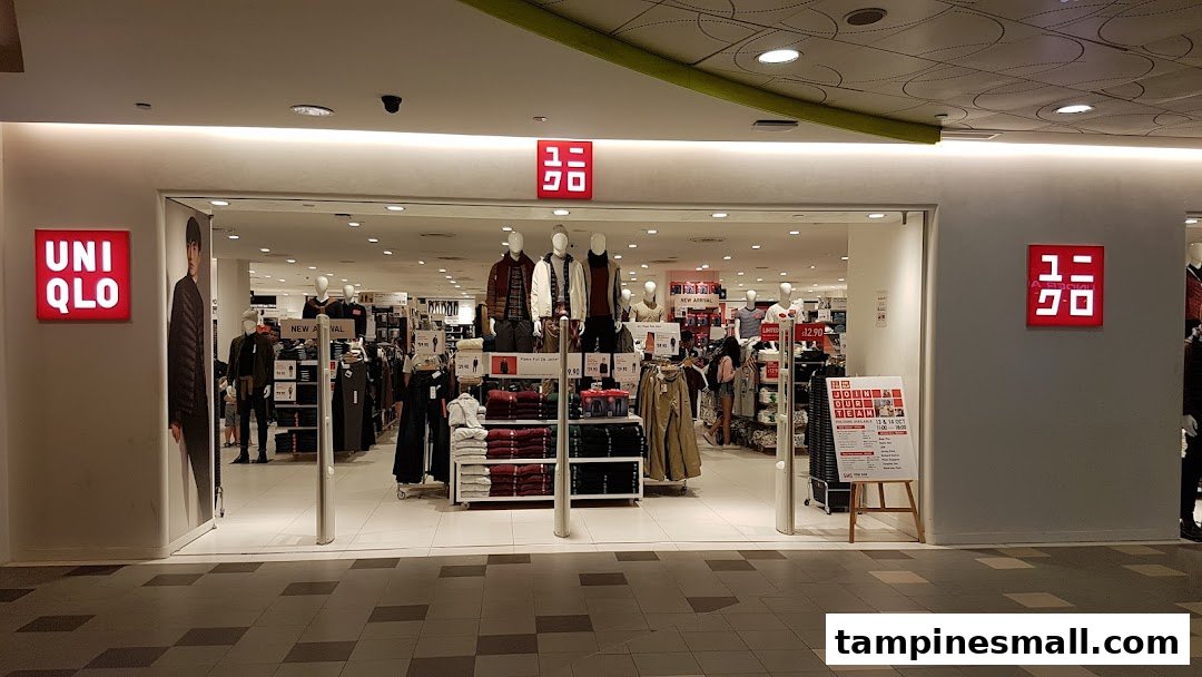 The brightly lit entrance of UNIQLO, showcasing mannequins and clothing displays inside.