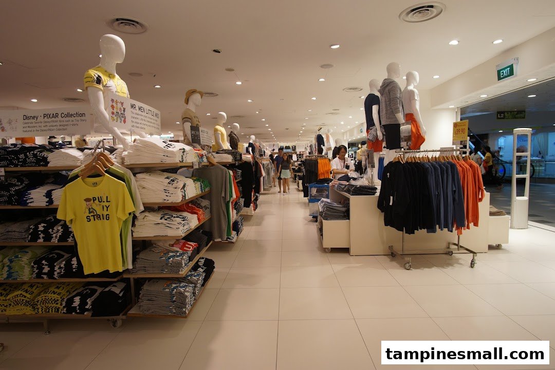 Interior view of UNIQLO showcasing diverse apparel collections, including Disney and Mr. Men Little Miss UT graphic tees.