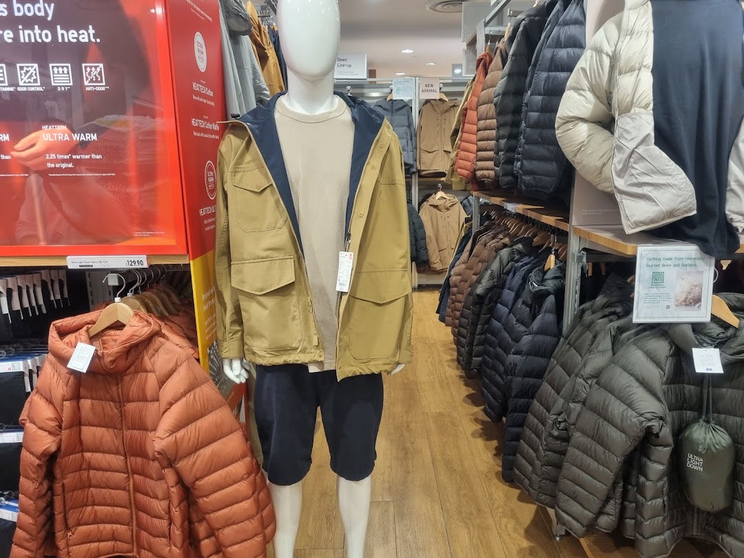 A display of UNIQLO's HEATTECH and Ultra Light Down jackets, showcasing winter apparel and warmth technology.