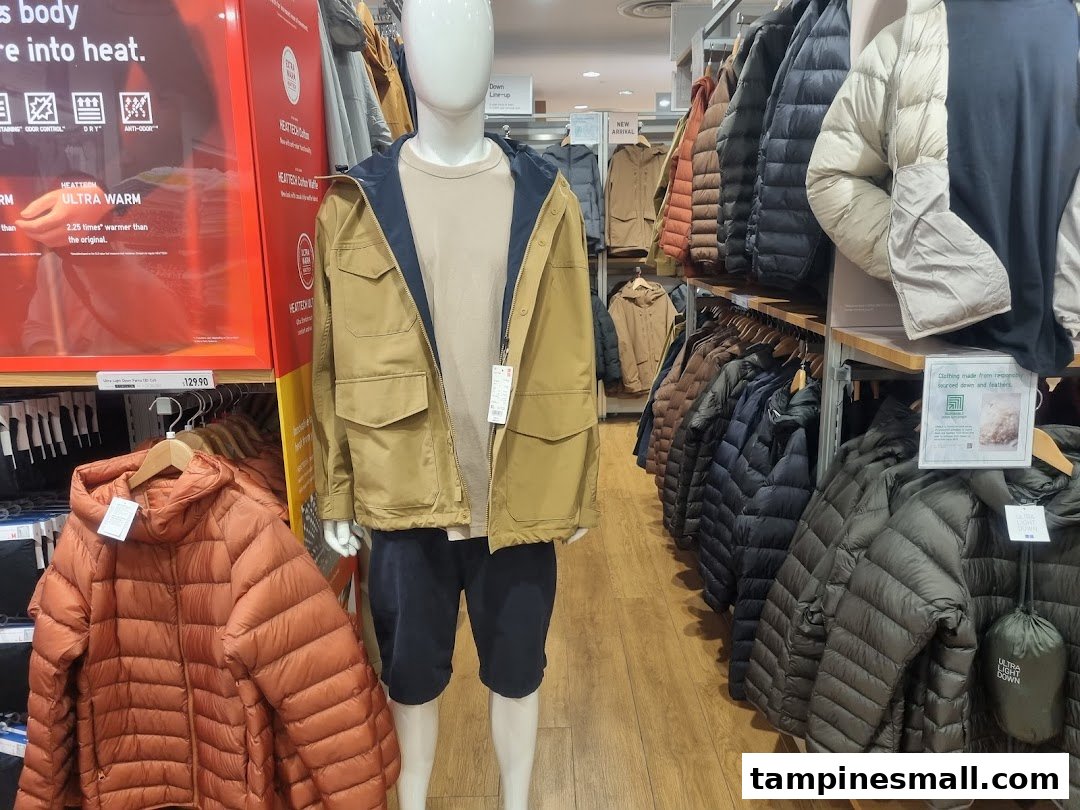 A display of UNIQLO's HEATTECH and Ultra Light Down jackets, showcasing winter apparel and warmth technology.