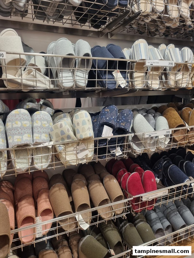 Shelves filled with a wide variety of comfortable room shoes and slippers in different colors and styles.