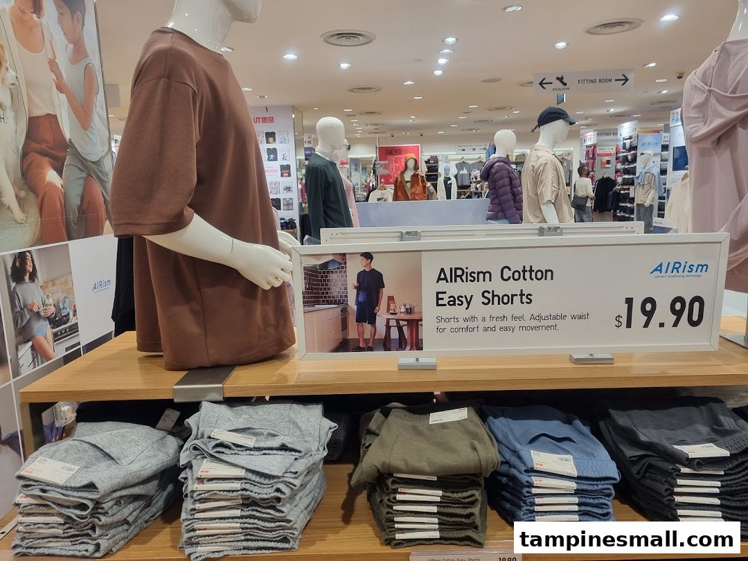 An in-store display at UNIQLO featuring AIRism Cotton Easy Shorts with mannequins and pricing.