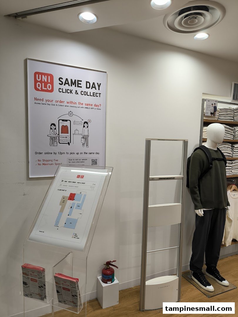 An in-store display at UNIQLO promoting their Same Day Click & Collect service, featuring a floor map and mannequin.