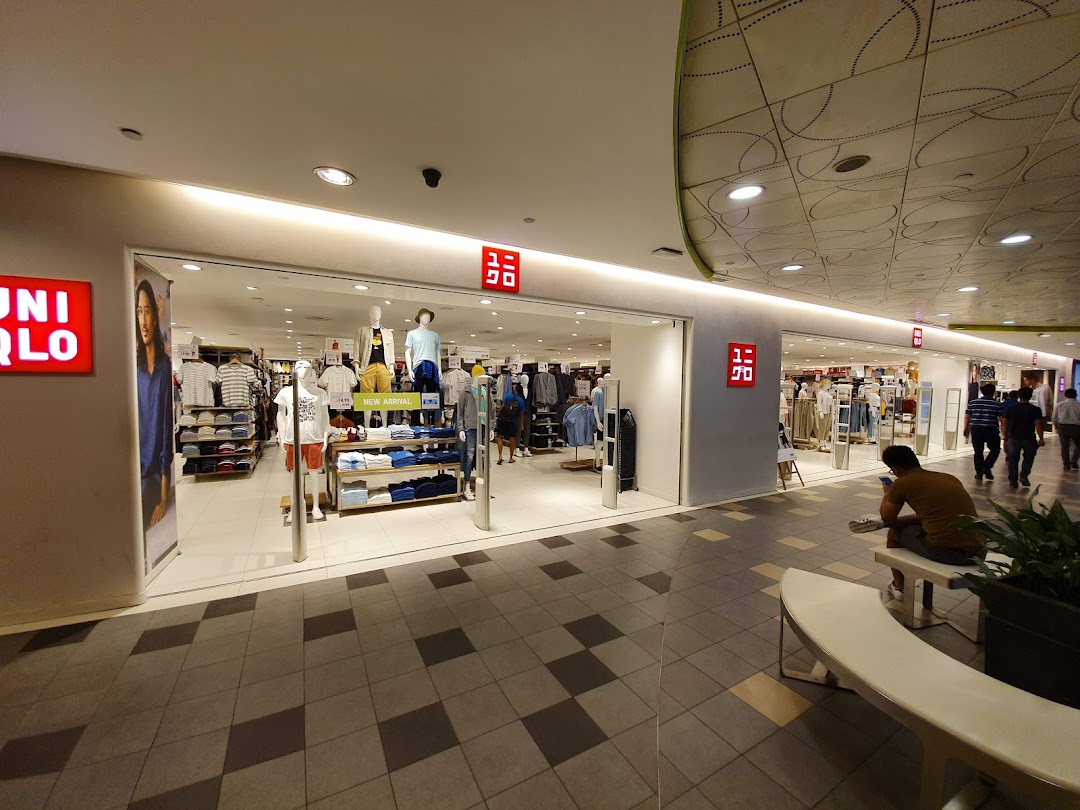 The brightly lit entrance of UNIQLO at Tampines Mall, showcasing new arrivals and clothing displays.