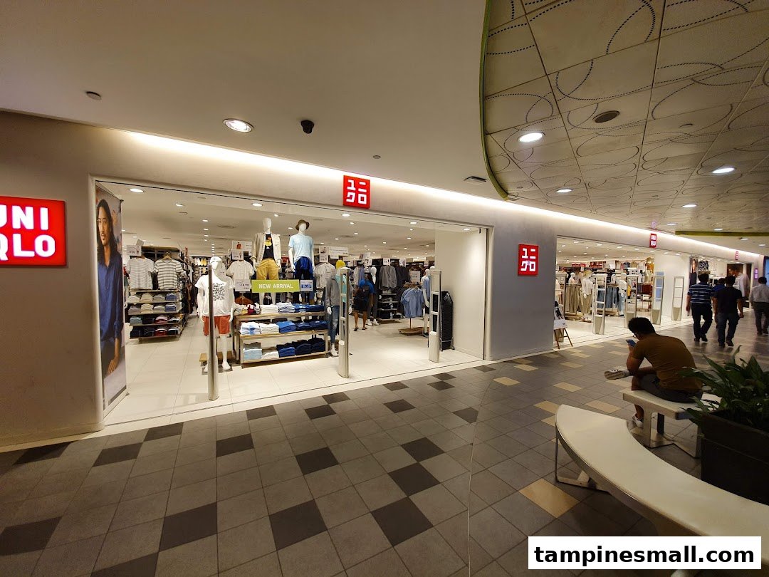 The brightly lit entrance of UNIQLO at Tampines Mall, showcasing new arrivals and clothing displays.
