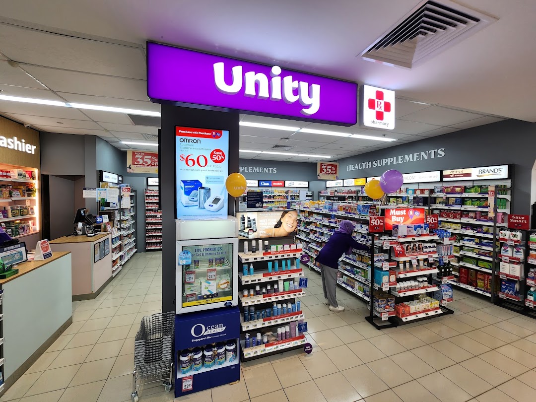 Interior view of Unity pharmacy, showcasing health supplements, personal care products, and a cashier counter.