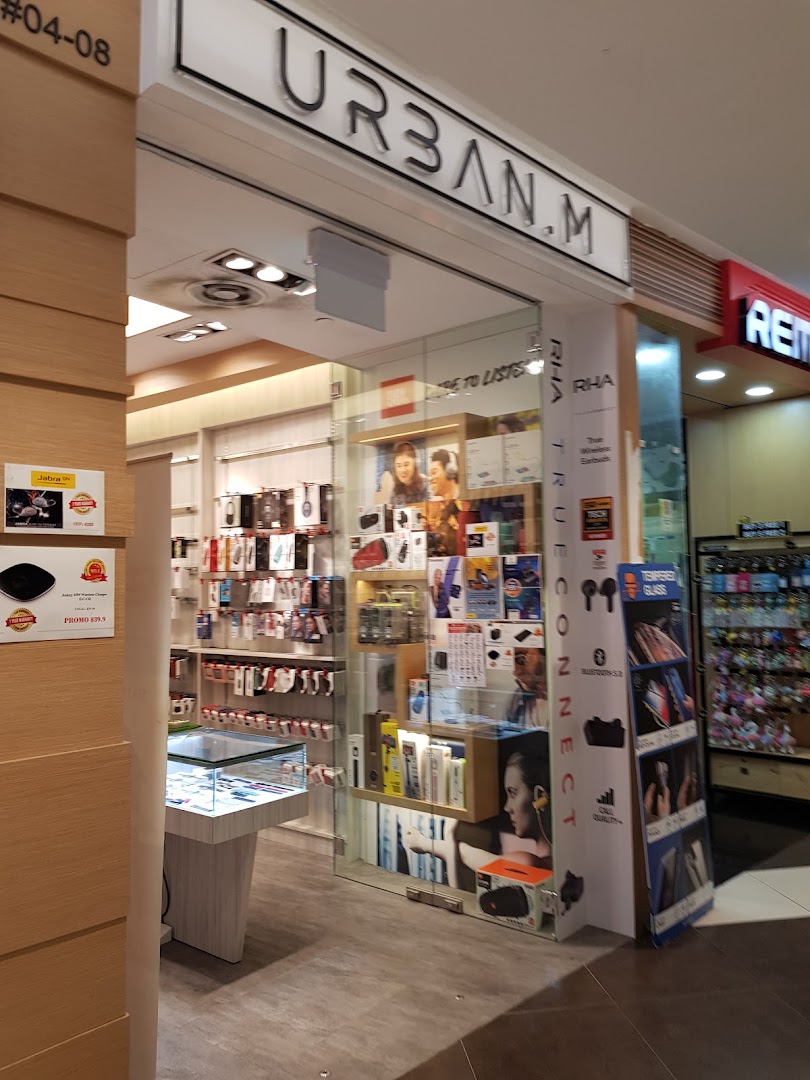 The storefront of URBAN.M, an electronics and accessories shop, showcasing various tech products and gadgets.