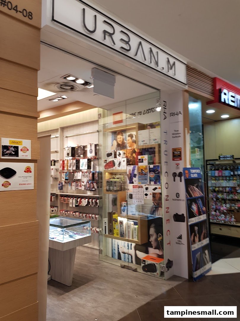 The storefront of URBAN.M, an electronics and accessories shop, showcasing various tech products and gadgets.