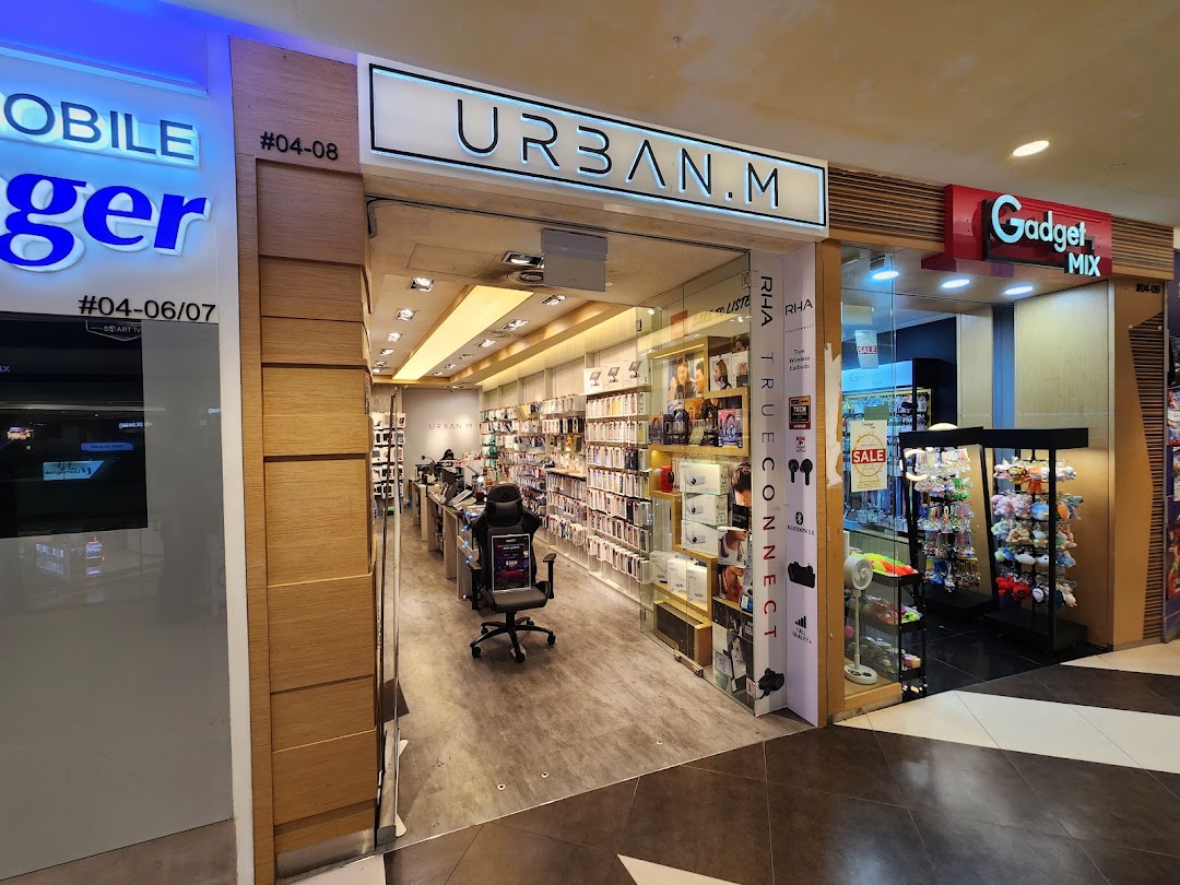 The storefront of URBAN.M, a modern electronics and gadget accessories shop, with its interior visible.