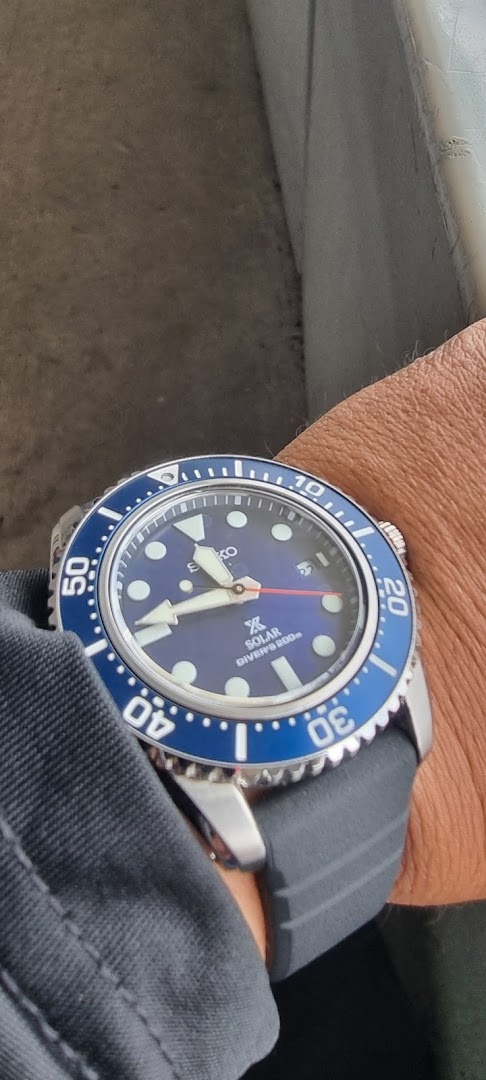 A close-up shot of a blue Seiko Solar Diver's watch worn on a person's wrist.