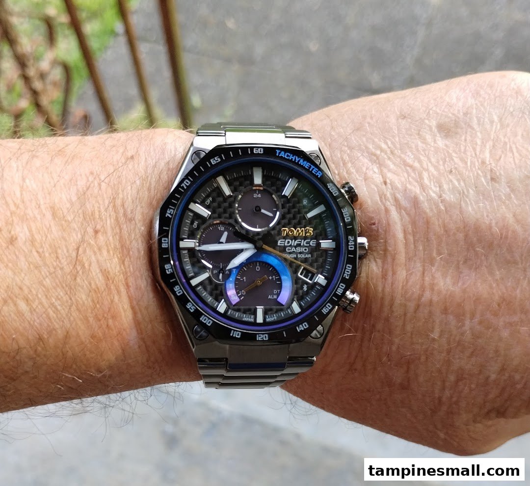 A close-up of a Casio Edifice watch with a carbon fiber dial on a person's wrist.