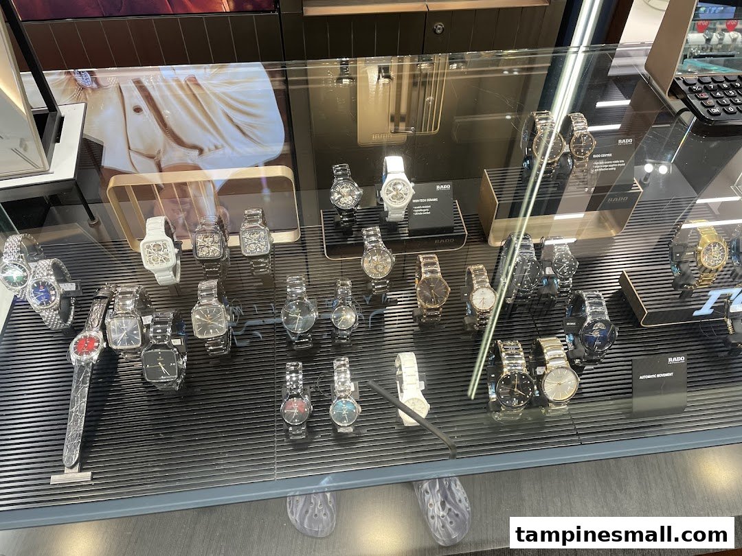 A close-up view of a glass display case showcasing a wide selection of luxury watches.