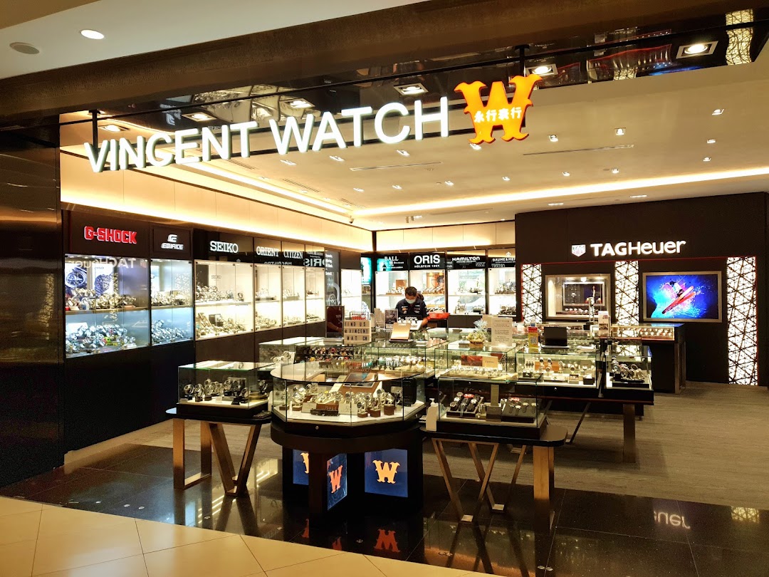 Interior view of Vincent Watch showcasing numerous luxury and fashion watch brands in display cases.
