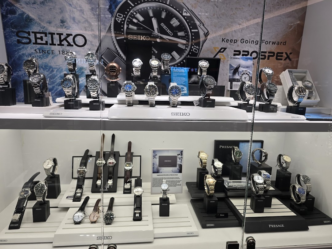 A vibrant display case showcasing a wide range of Seiko watches, including Prospex and Presage collections.