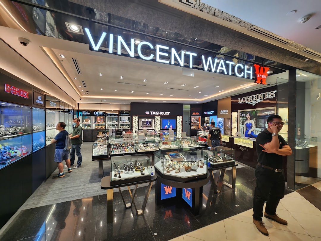 Interior view of Vincent Watch, a luxury watch retailer, showcasing various brands and customers browsing.
