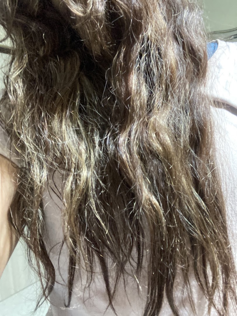 Close-up of a client's hair, showcasing texture and color after a salon treatment.