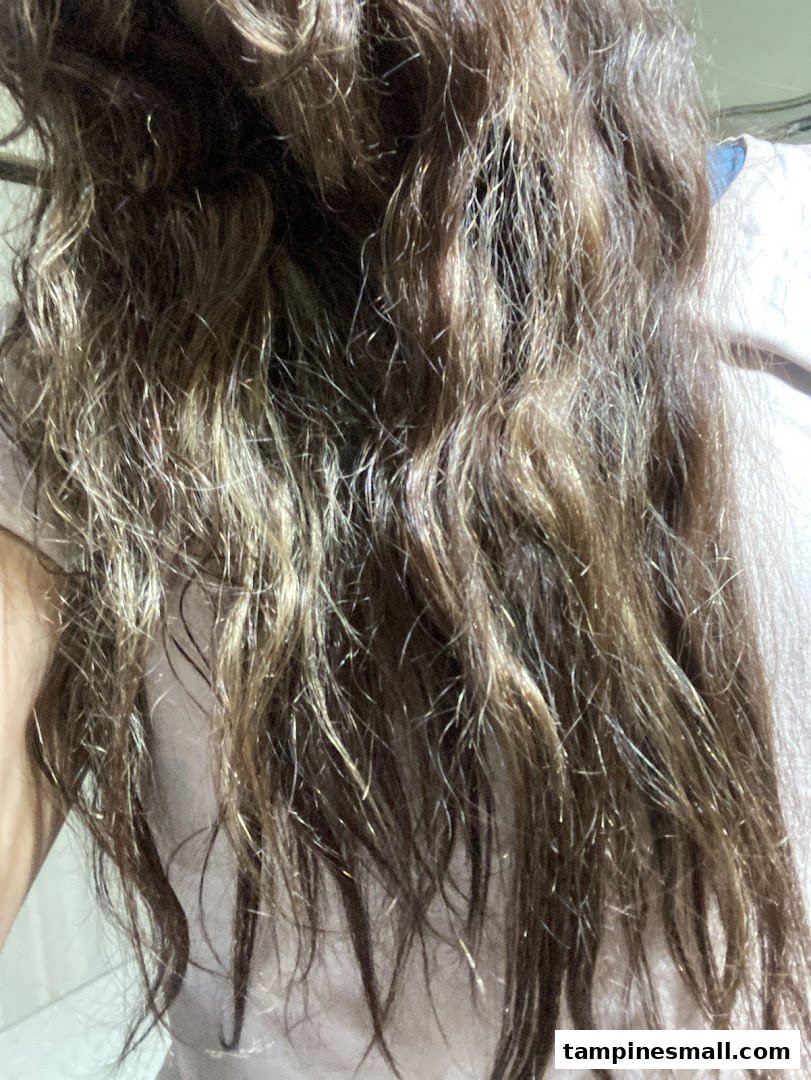 Close-up of a client's hair, showcasing texture and color after a salon treatment.