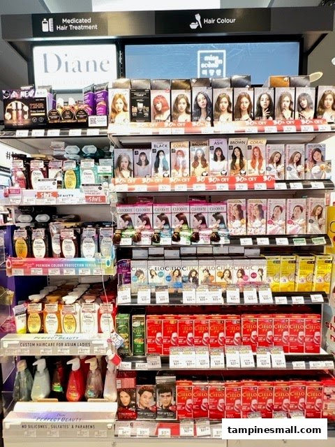 Shelves displaying a wide range of hair treatment, shampoo, and hair color products in a pharmacy.