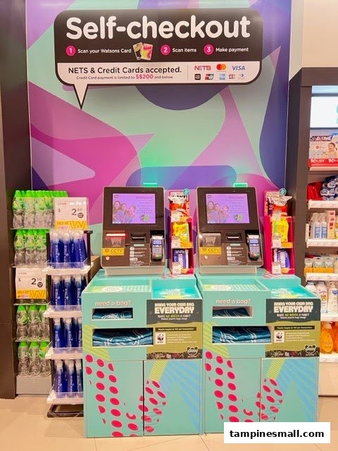 Watsons self-checkout kiosks with payment options and nearby health and beauty products.