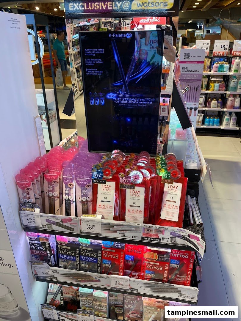 A vibrant in-store display at Watsons featuring K-Palette eyeliners and mascaras with promotional offers.