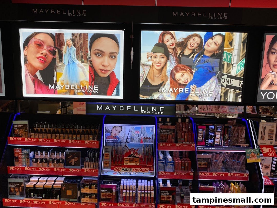 A vibrant Maybelline cosmetics display featuring makeup products and promotional signage within a retail store.