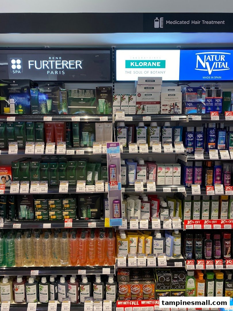 A retail shelf displaying various hair care products from brands like Rene Furterer, Klorane, and Natur Vital.
