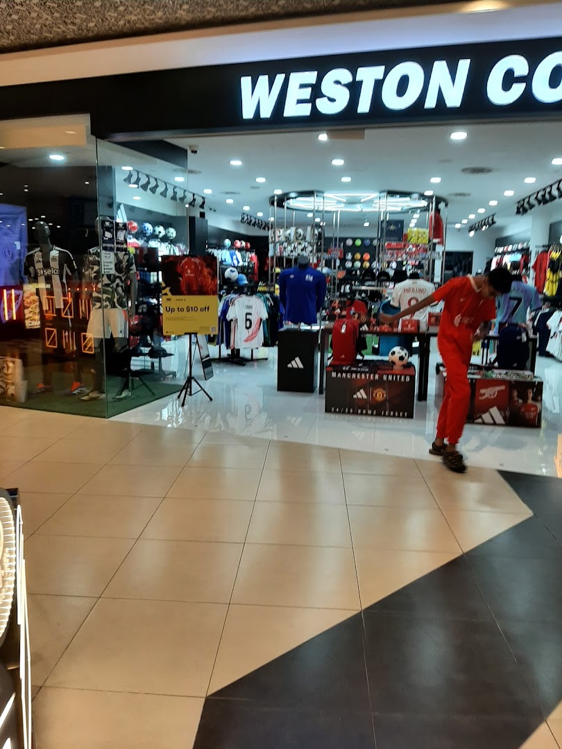 The shop front of Weston Corp, a sports apparel store, showcasing jerseys and sports merchandise.