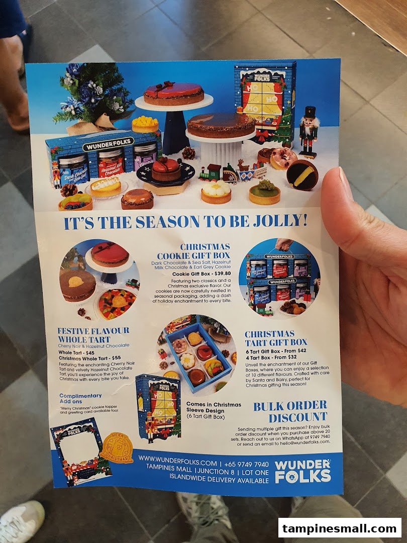 A festive Christmas menu flyer from Wunderfolks, showcasing holiday-themed tarts, cookies, and gift boxes.