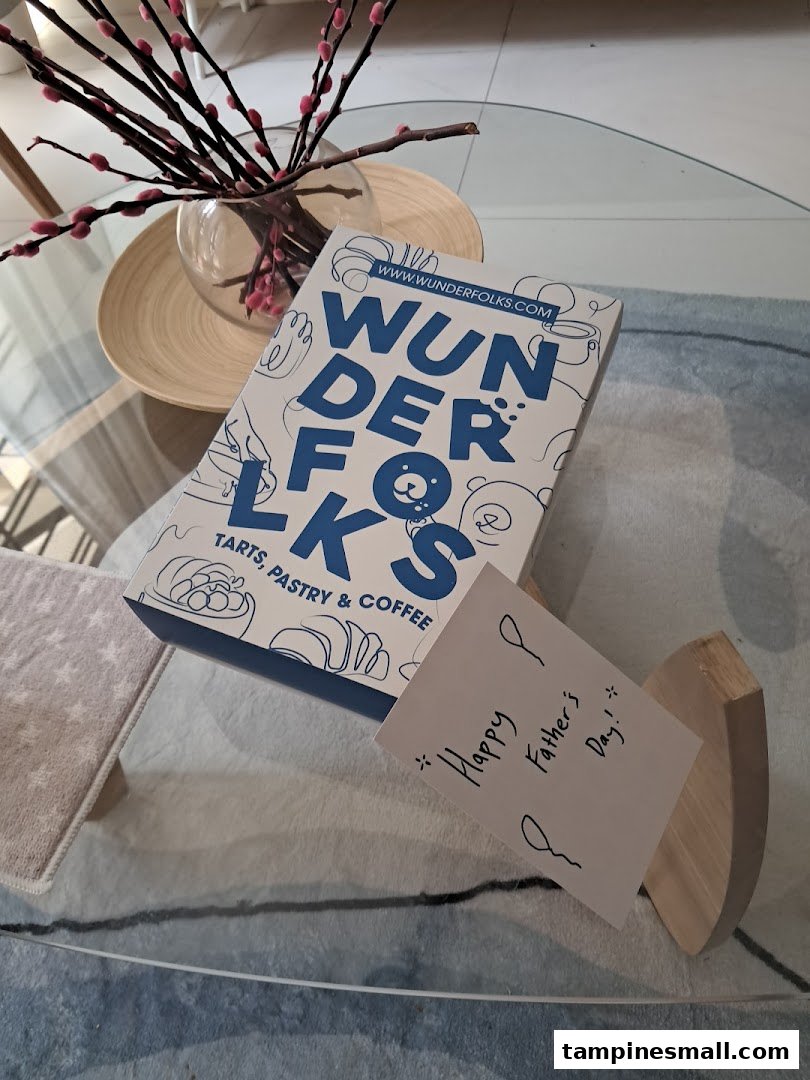 A Wunderfolks Pastry & Coffee box and a 'Happy Father's Day!' note on a glass table.