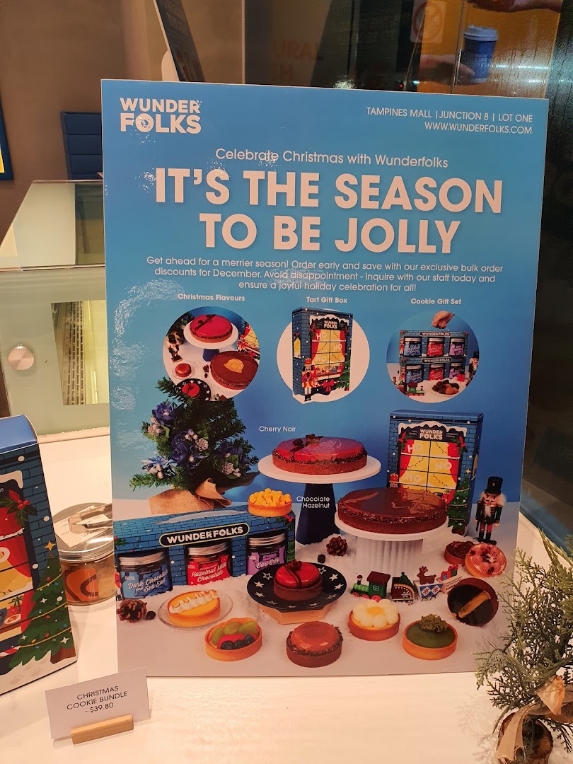 A festive display showcasing Wunderfolks' Christmas pastries, tarts, and cookie gift sets.