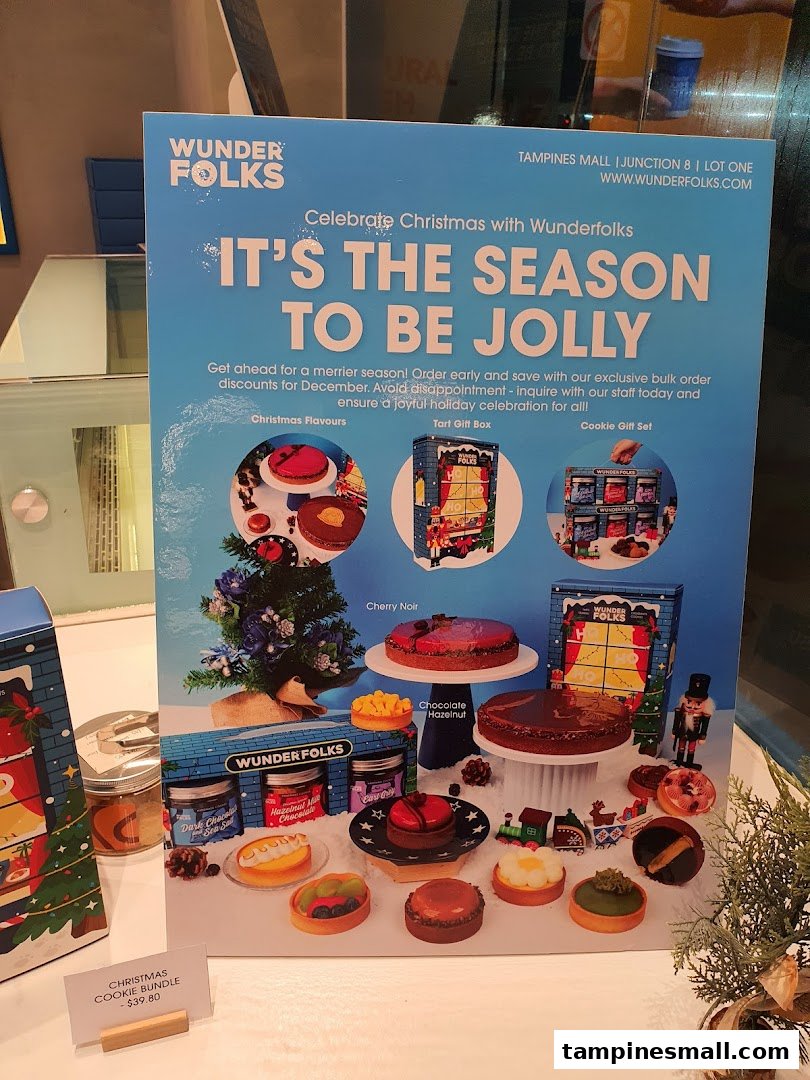 A festive display showcasing Wunderfolks' Christmas pastries, tarts, and cookie gift sets.