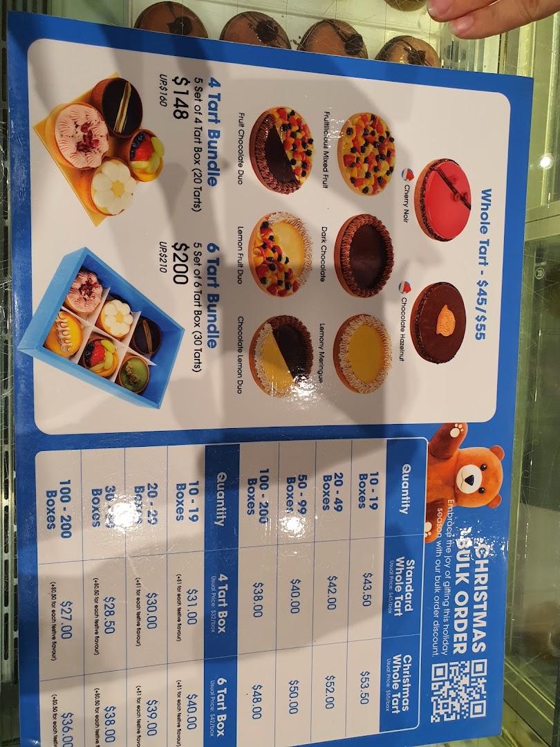 A menu board displaying various tart flavors, bundle deals, and bulk order pricing for pastries.
