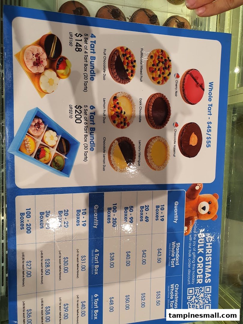A menu board displaying various tart flavors, bundle deals, and bulk order pricing for pastries.