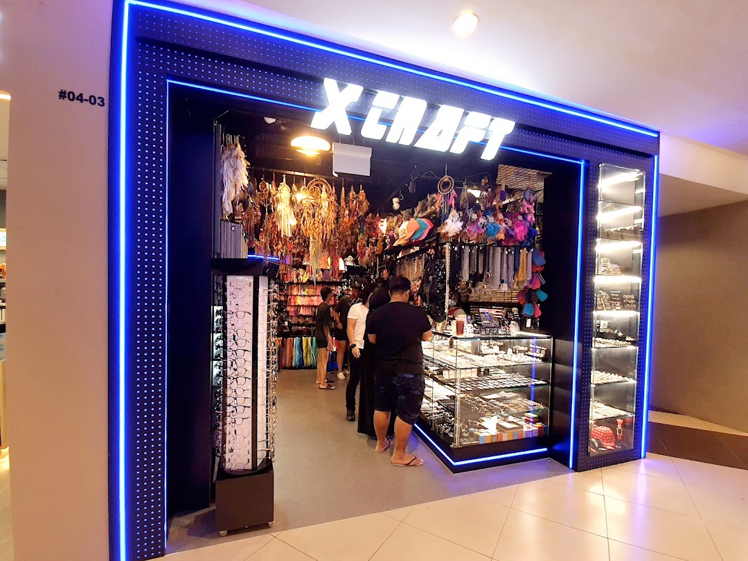 The illuminated entrance of X-Craft, a vibrant shop offering a wide array of accessories and unique gifts.