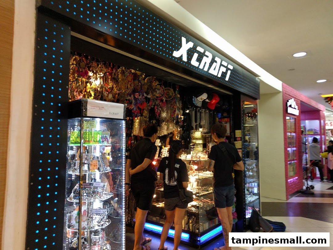Customers browse unique accessories and gifts at the X-Craft shop entrance in a mall.