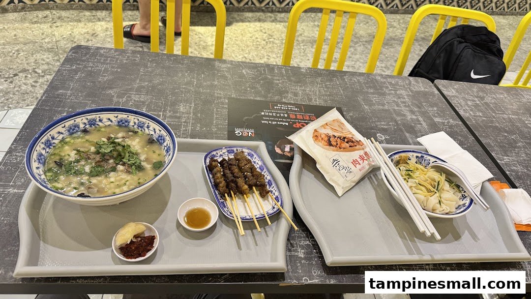 A table laden with various delicious Xi'an dishes, including soup, skewers, and noodles.