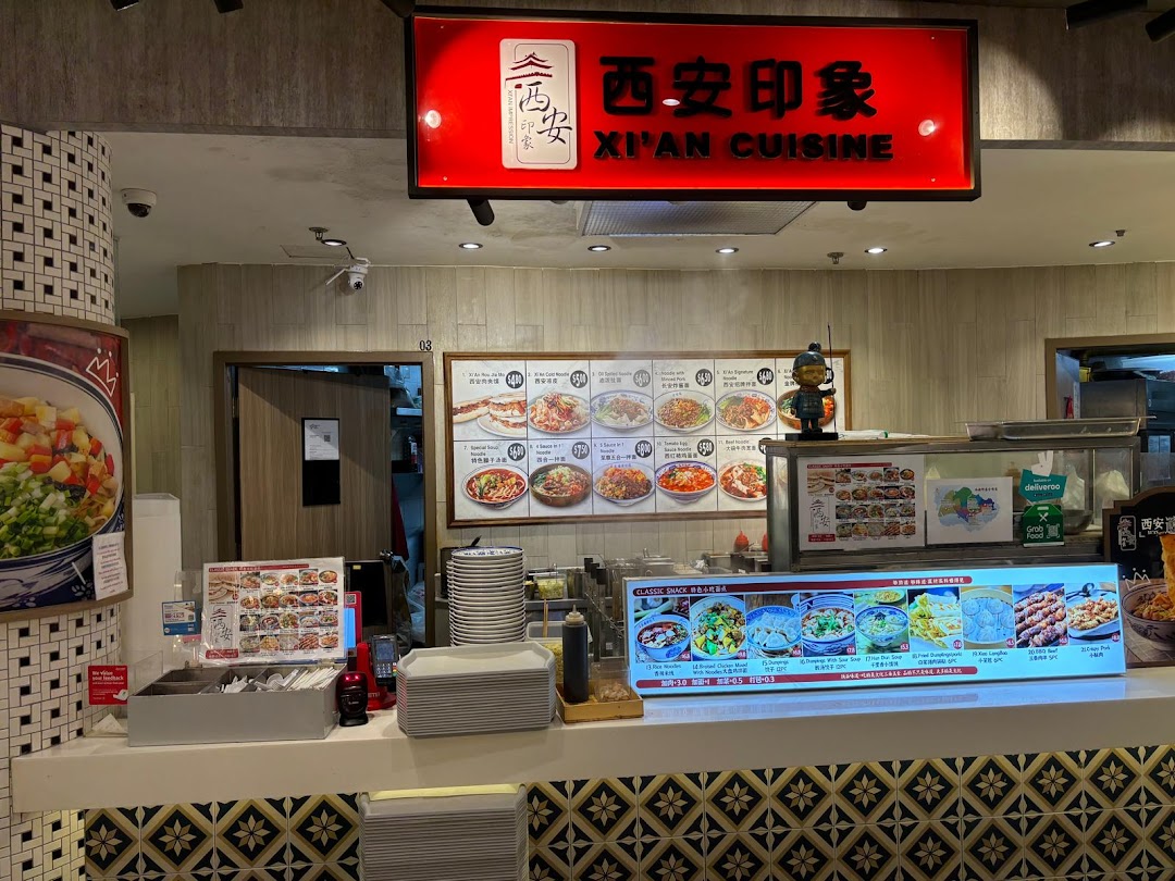 A vibrant counter of Xi'an Cuisine, showcasing their diverse menu boards and inviting setup.